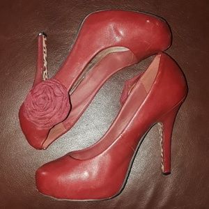 Red faux leather heels with rose accent